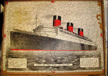 old jigsaw with picture of a cruise liner