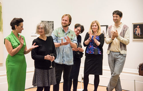 Artists clapping at a private view