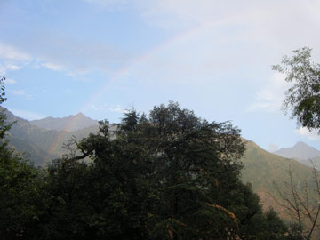 View of mountain with rainbow in the sky