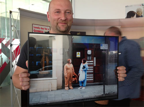 man holding a framed photograph