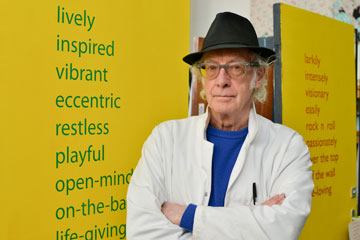 Roger McGough by poetry-covered doors