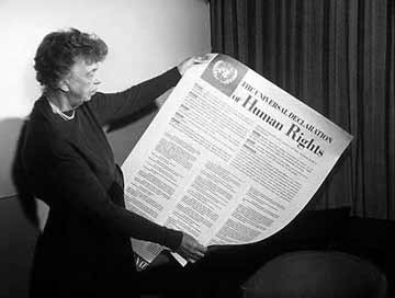 Eleanor Roosevelt holds up a copy of the Universal Declaration of Human Rights