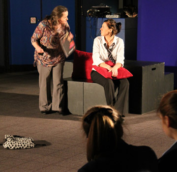 school pupils watching performance of play