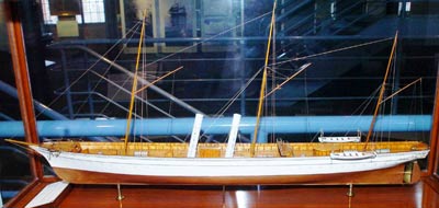 small wooden model of a long thin masted ship