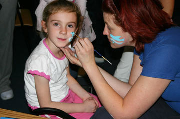 child having their face painted
