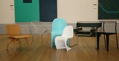 A row of different coloured contemporary chairs