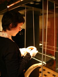 curator taking object out of case