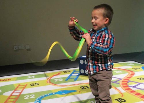 Boy enjoys snakes exhibition