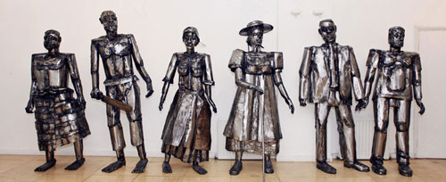 steel sculpture of six standing figures
