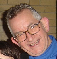 a smiling man wearing glasses