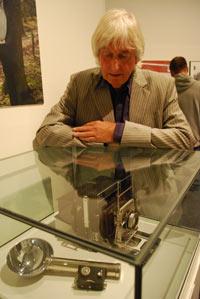 Stephen Shakeshaft looking at an old camera in a display case