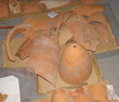 a complete, terracota coloured cone, with broken ones scattered around