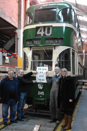 people holding a 'Tram of the Year' sign by Tramcar 245