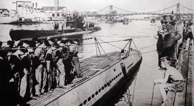 Photograph of a shipyard with a row of men