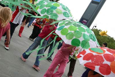 children parading with colourful, decorated umbrellas
