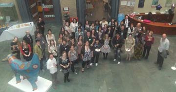 A large group of volunteers and staff at a celebration event in World Museum