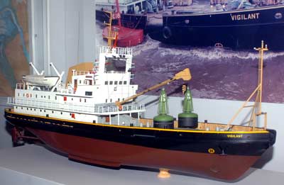 photo of a modern ship model with two green buoys on the deck