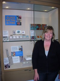 Lady stands infront of display case