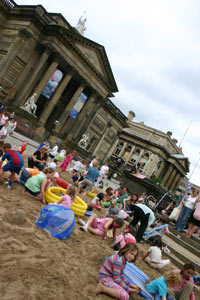 families in sand pit in front of the Walker Art Gallery