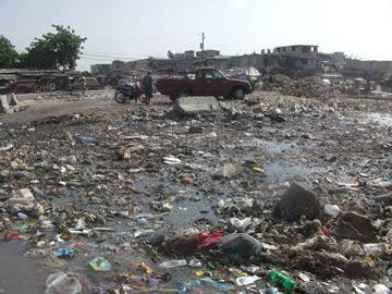 rainy street in Haiti full of post-earthquake debris