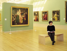Woman holding a book in a gallery