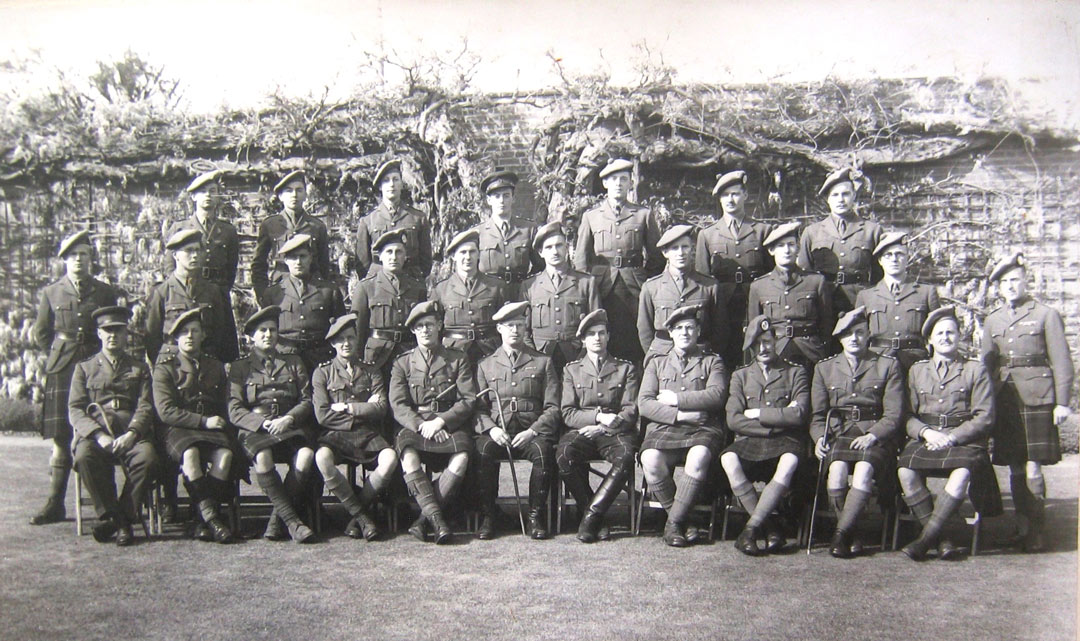 formal group photo of soldiers in uniform with kilts