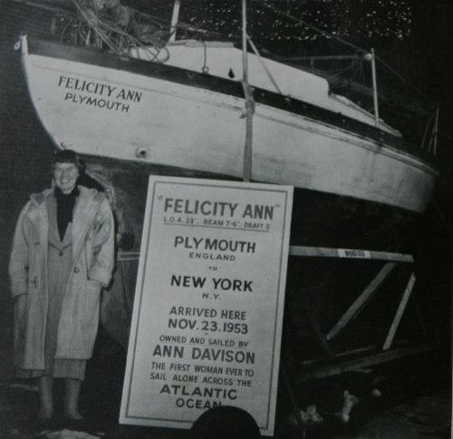 Ann Davison by yacht 'Felicity Ann' and sign with text: Felicity Ann, Plymouth England to New York, NY, arrived here 23 Nov 1953. Owned and sailed by Ann Davison, the first woman ever to sail alone across the Atlantic Ocean