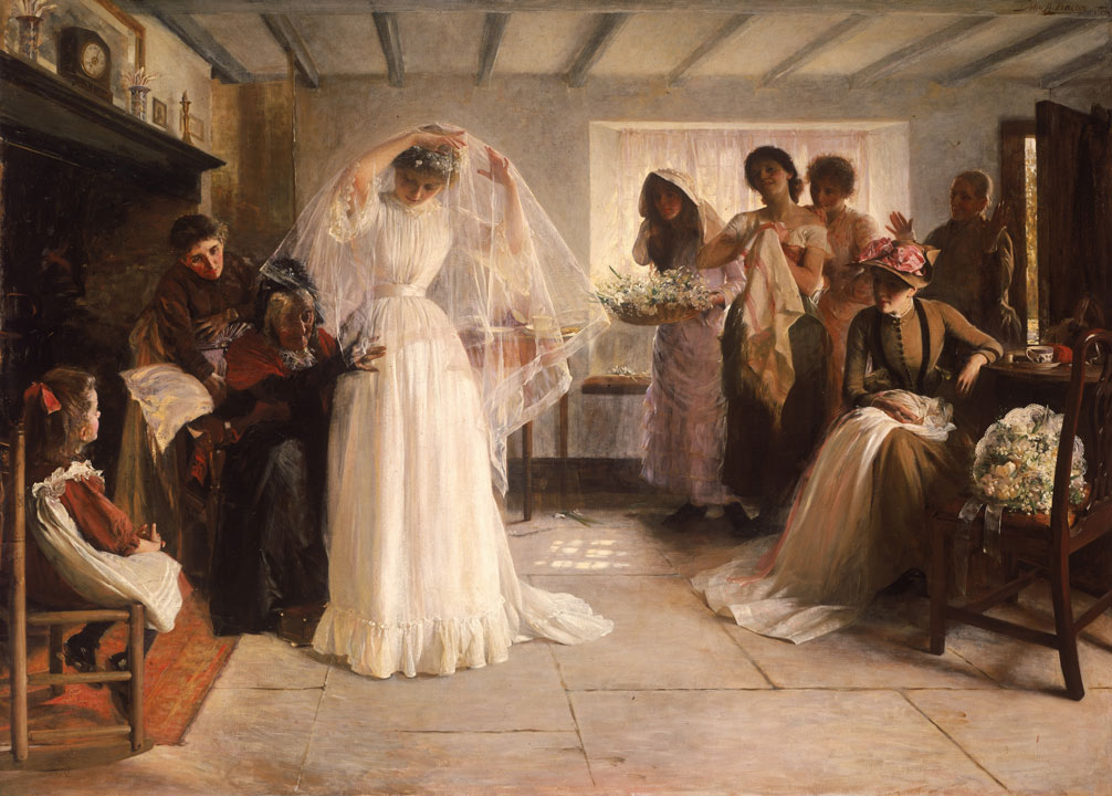women helping a bride get ready, one is adjusting her dress as she lifts her veil