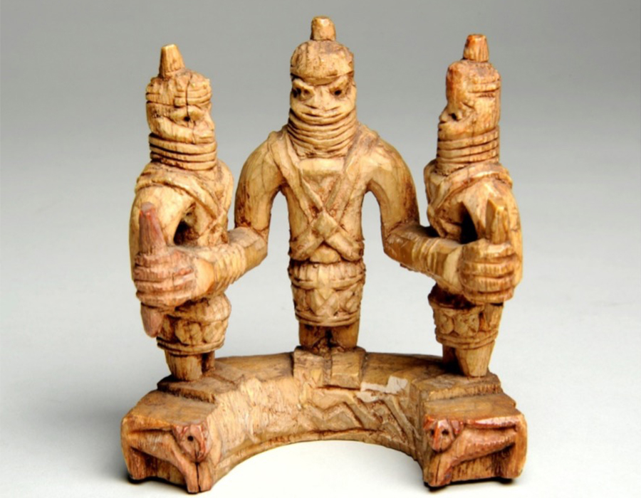 Benin ivory group showing figures wearing beaded headdresses and regal costume. An Oba at the centre is supported by an official on each side. Purchased in April 1898 from Dr Felix Roth (World Museum 21.12.97.6)