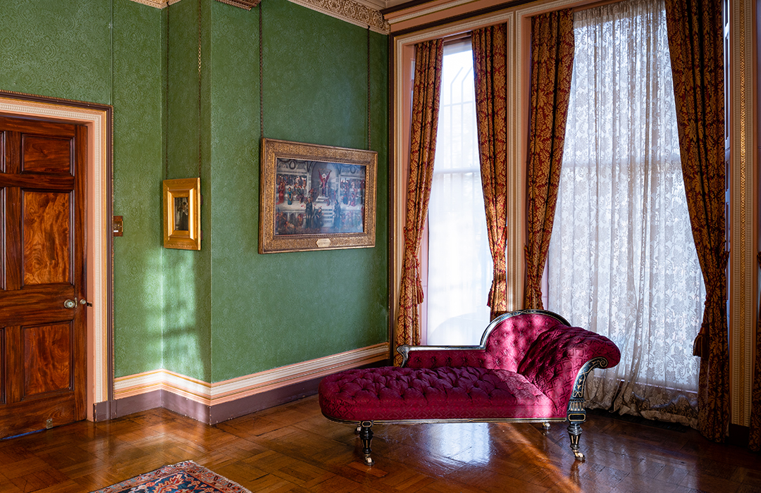 Drawing room with velvet chaise longue and bay windows