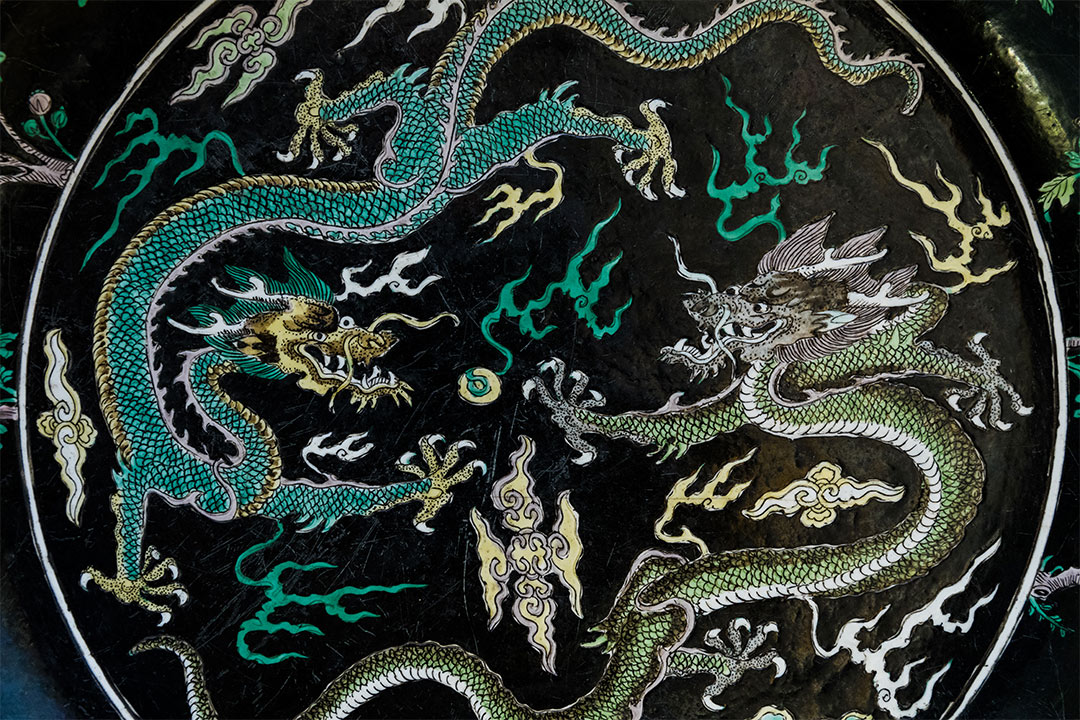 detail of two Chinese dragons on a decorative plate