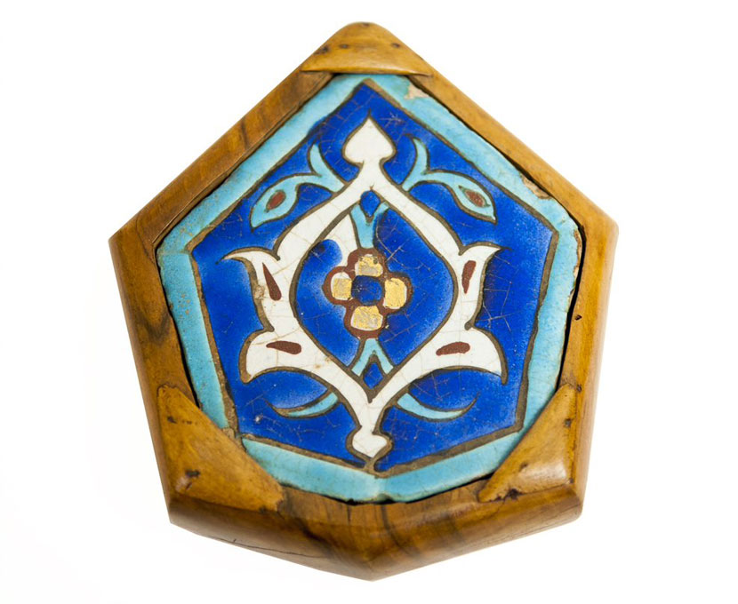 Patterned hexagonal blue tile in wooden setting