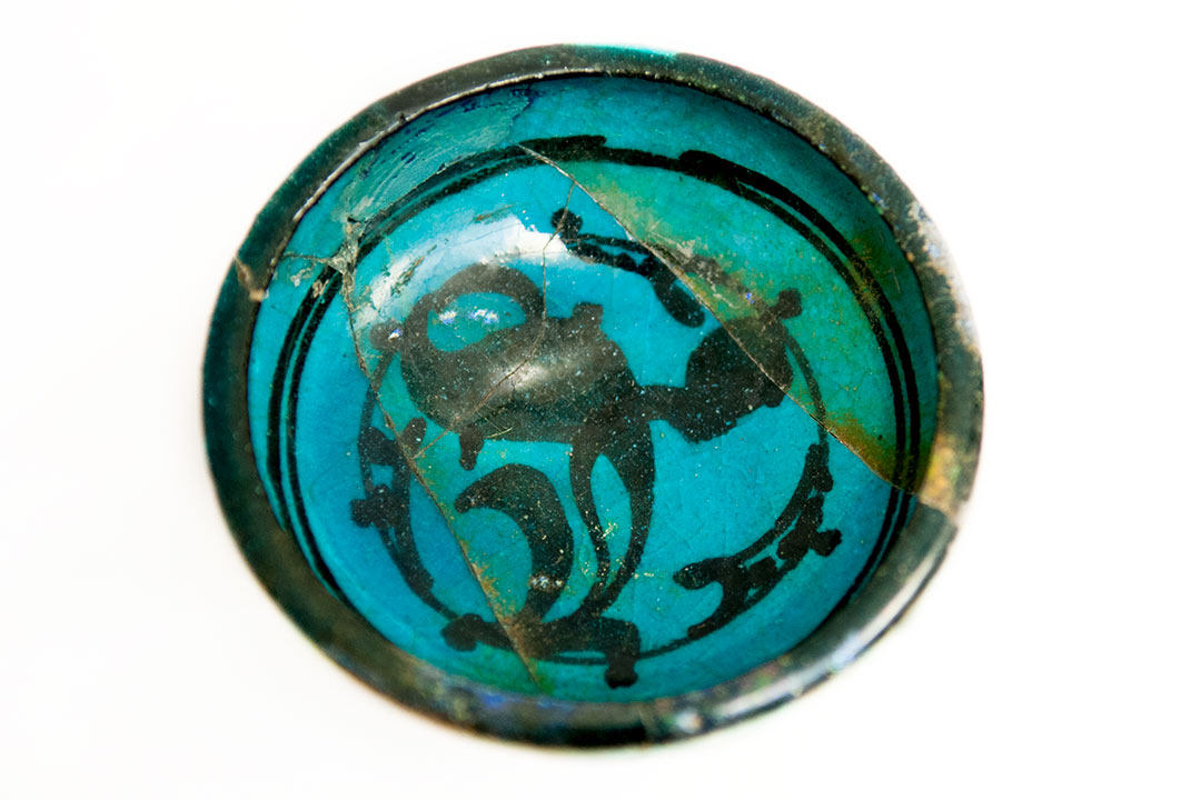 Blue ceramic bowl with swirling black decoration