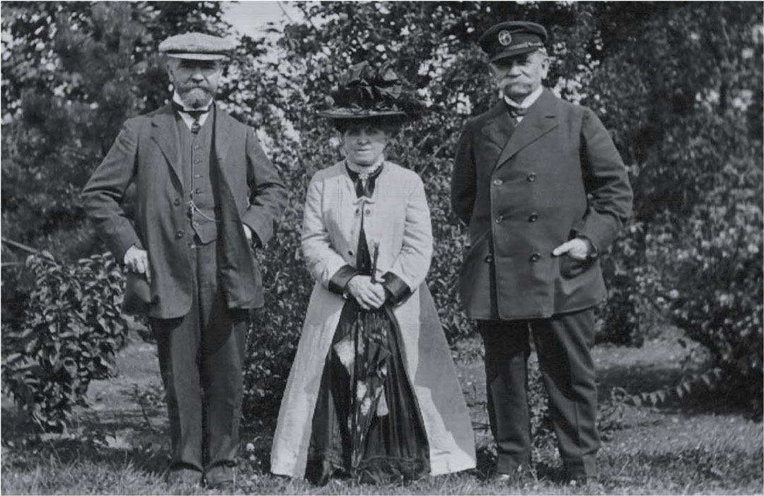 Lady lever, a short woman in a huge hat, standing between two men
