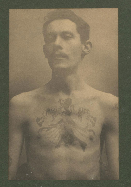 Robert MacFie bare chested, showing large tattoo