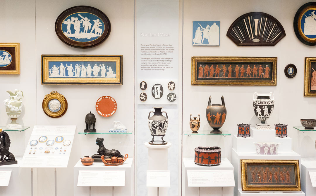 Wedgwood vases, plaques and other items in display case 