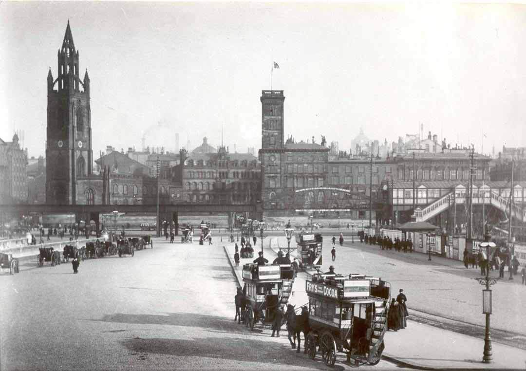 Old photo with horse drawn carriages and overhead railway in front of church and Tower building