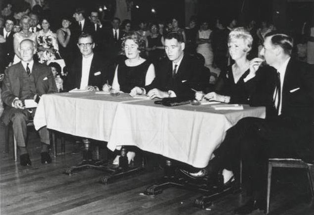Miss Meccano beauty contest judges sitting at a table