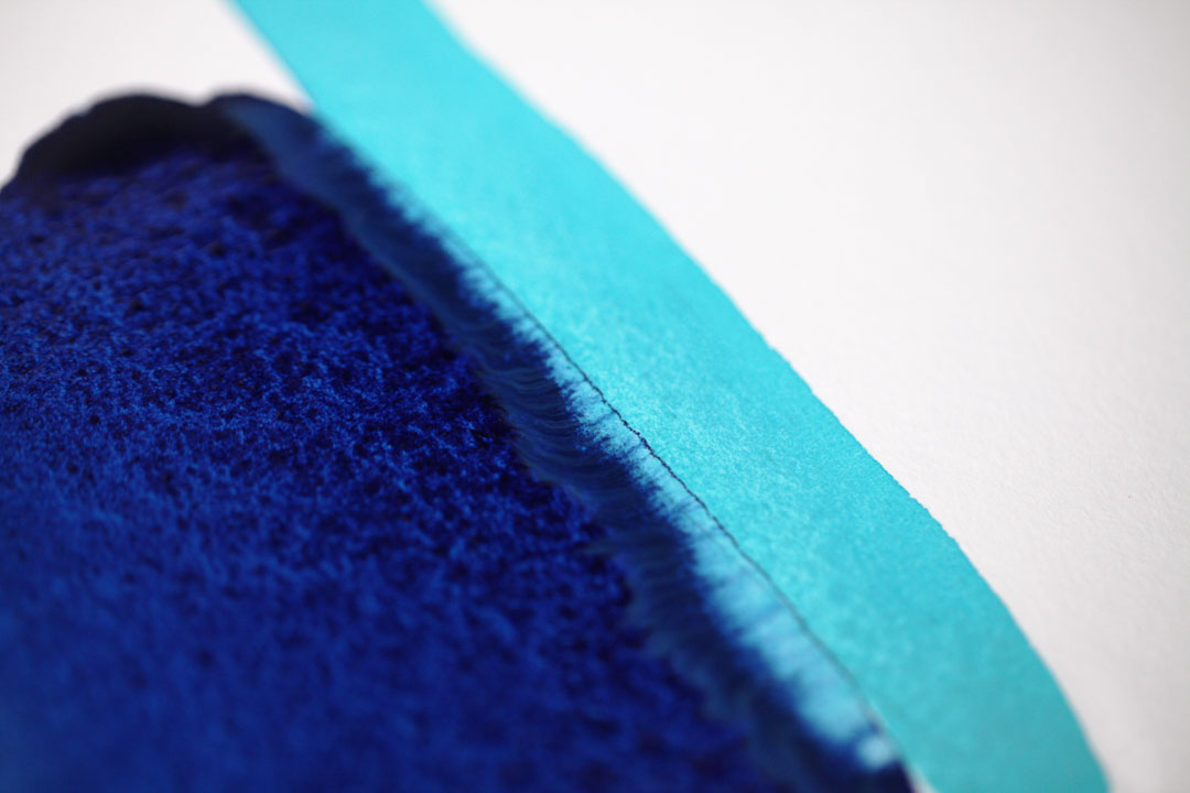 Close up shot of blue watercolour paint on paper
