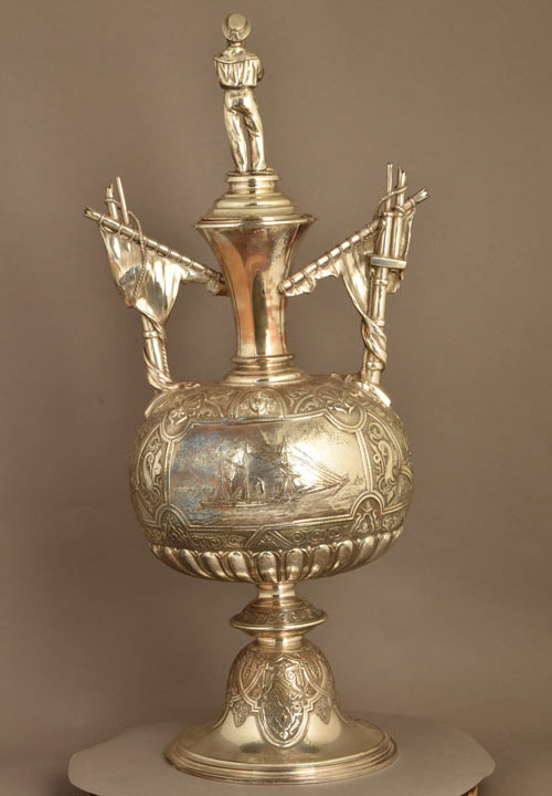 tarnished silver trophy, with a lean to one side