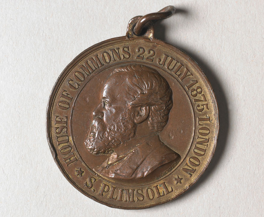 Medallion with man's head and text: S Plimsoll, House of Commons 22 July 1875 London