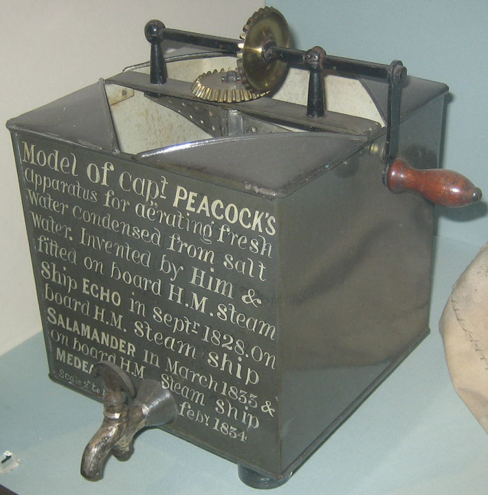 metal box with winding handle and tap, inscribed:  Model of Capt. Peacock's apparatus for aerating fresh water condensed from salt water. Invented by Him & fitted on board HM steamship Echo in Sept 1828, on HM steamshio Salamander in March 1833 & on HM steamship Medea Feb 1834