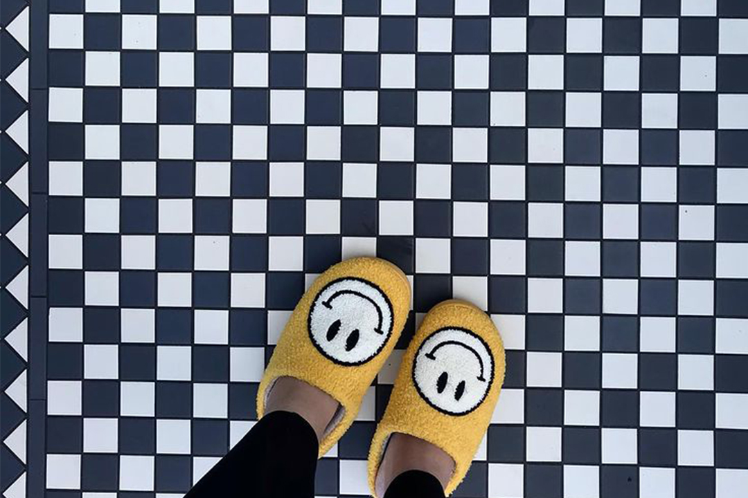 Smiley slippers on Victorian checked door step