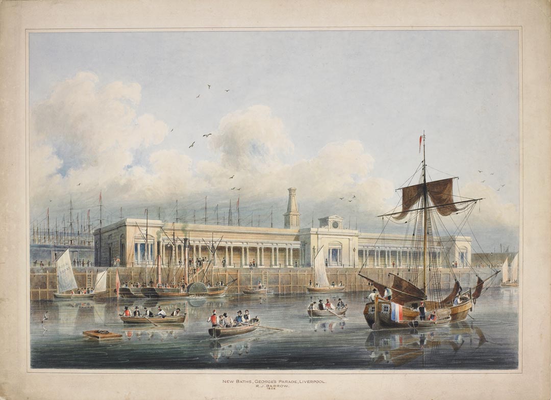 Long white building on the waterfront, with many boats and ships in the river in the foreground