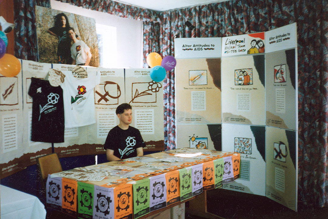 Andrew ata. stall surrounded by promotional posters