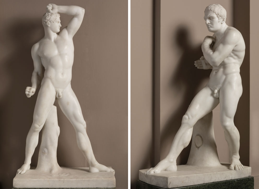two marble sculptures of naked muscular men 