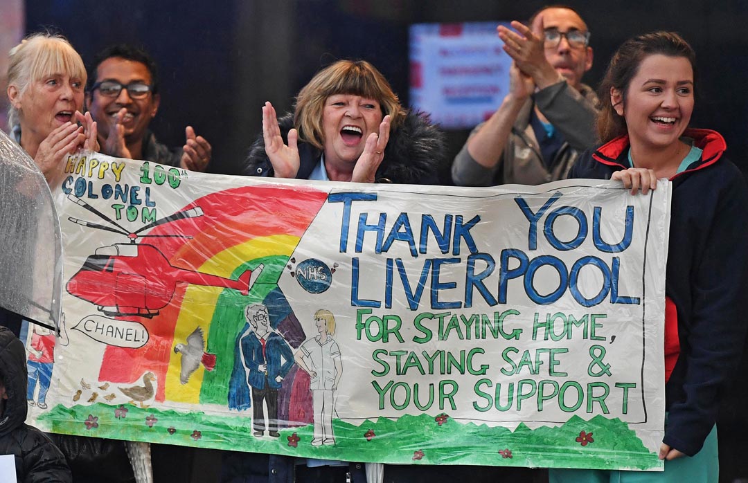 hospital staff clapping with banner with message: Thank you Liverpool for staying at home, staying safe and your support