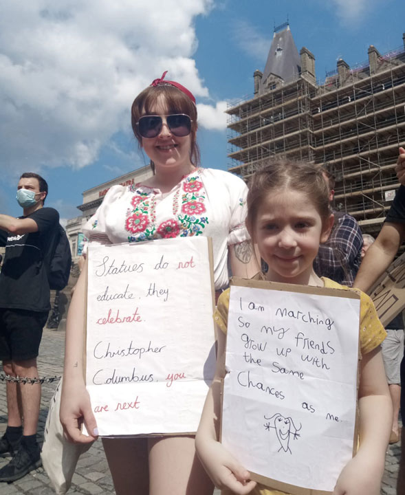 mother and daughter holding placards