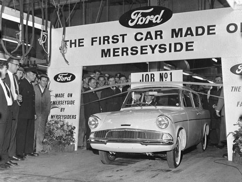 banner and factory workers celebrating the first car made at Halewood