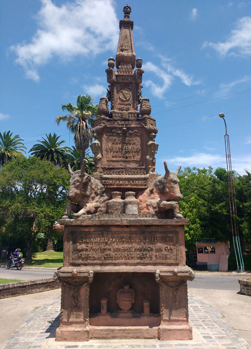 carved stone monument featuring two cow figures